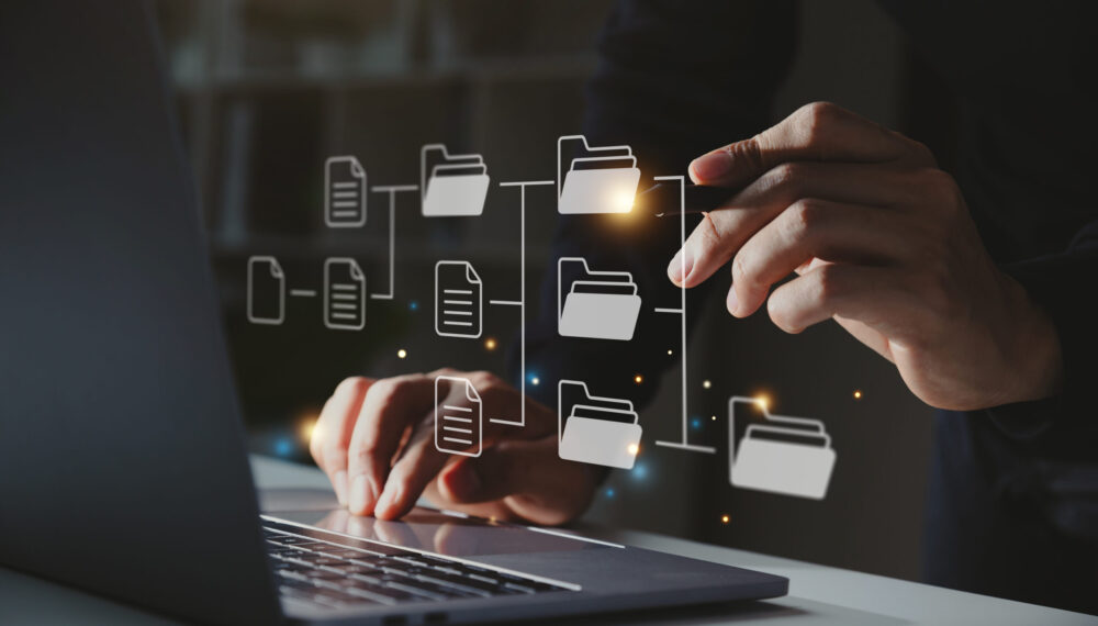Document management concept. Businessman using a computer to document icons on virtual screen.